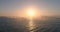 Sea sunrise, flying seagulls and sailing cargo ship against in foggy morning. Aerial 4K video