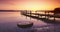 Sea sunrise ot sunset and wooden old jetty pier for fishermen. Travel and beautiful nature