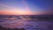 Sea sunrise. Rising sun and colorful sky clouds over ocean waves and beach
