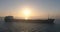 Sea sunrise and sailing cargo ship in morning fog, spectacular aerial 4k video
