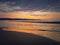 Sea sunrise with seagulls flying above the foamy waves. Peaceful morning seaside