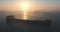 Sea sunrise and spectacular aerial view over sailing cargo ship, beautiful morning over ocean waves