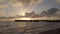 Sea sunset with light reflections and the silhouette of the people on the pier