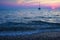 Sea sunset. Stones on the beach. The ship in the distance, arrives