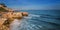 Sea surf in Albufeira beach and mountain in Portugal.