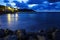 Sea surf on a long exposure in the evening.Dark blue mood. In the foreground, wet rocks