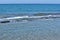 Sea surf rolling over an underwater natural stone slab