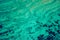 Sea surface aerial view. Background image of the turquoise sea. Deep sea and corals. Aerial drone shot of turquoise water, space