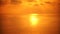 Sea surface small waves against golden slow motion sunrise. Large disk of the sun rises above the sea blurred background
