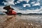 The sea tide with a lonely red fishing boat