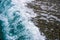 Sea tide on a pebble shore. Waves with white foam on a pebble beach. Nature concept, background