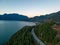 Sea to Sky Highway on West Coast of Pacific Ocean. Aerial Mountain Landscape. Twilight sky.