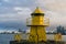 Sea transportation and navigation. Lighthouse on sea pier in reykjavik iceland. Lighthouse yellow bright tower at sea