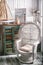 Sea travel styled shabby chic interior corner with map wicker ch