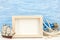 Sea vacation background with photo frame and sailboat against bl