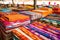 sea of vibrant, handmade quilts spread out for sale