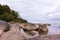 Sea view with cloudy blue sky, green forest and different rocks