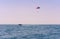 Sea view of a man Parasailing in the water towed by a speedboat in American flag colours