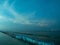 Sea view near mangrove forest with man made wooden barrier for wave protection, under starry nigh cloudy sky