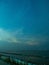 Sea view near mangrove forest with man made wooden barrier for wave protection, under starry nigh cloudy sky