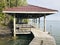 Sea view pavilion and wooden bridge walkway along the sea of `Mature mangrove forest and black sand beach` in Trat, Thailand.