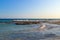 The sea view. Rocky shoal. The waves run to the shore. Evening. Cyprus