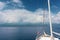 A sea voyage on a yacht. Island and cloudy sky in the background