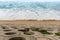 Sea wall exposed after the storm and a sandy beach with high tide at North Cronulla, NSW