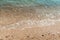 Sea water and beach sand in Faraglioni stacks and beach coast of Mergoli, Vieste Gargano, Puglia, Italy. Europe