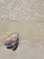 Sea water crashing a colourful stone at the beach