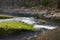 Sea water flows over rocks mosses