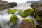 Sea water flows over rocks and mosses