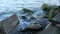 Sea water and a shore covered with large stones