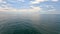 Sea water surface. Aerial view on calm water surface, camera flies over clear sea ocean. Sun glare. Abstract nautical