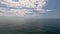 Sea water surface. Aerial view on calm water surface, camera flies over clear sea ocean. Sun glare. Abstract nautical