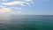 Sea water surface. Aerial view on calm water surface, camera flies over clear sea ocean. Sun glare. Abstract nautical