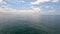 Sea water surface. Aerial view on calm water surface, camera flies over clear sea ocean. Sun glare. Abstract nautical