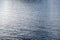 Sea water surface background. Calm blue water rippled with reflections