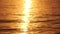Sea water surface sunset. Low angle view over golden sea water. Sun glare. Abstract nautical summer ocean nature