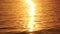 Sea water surface sunset. Low angle view over golden sea water. Sun glare. Abstract nautical summer ocean nature