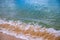 Sea water tide over yellow sand beach. Tropical seaside concept photo. Foamy sea wave on sand beach
