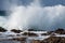 Sea wave breaking against coast rock