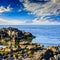 Sea wave breaks about boulders