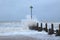 Sea wave hit wooden groyne