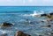 Sea wave hitting the coast rocks