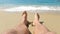 Sea wave hitting a man\\\'s feet. Feet wet by the waves of sea water, Legs and feet on the sand of the beach with the waves