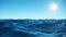 Sea wave low angle view. Ocean water background. View from below, view of a clear blue sky with the sun. Sea or ocean