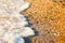 Sea wave over the pebbles on the beach, abstract natural background