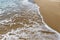 Sea wave runs on wet sand. Natural background