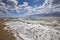 Sea wave surf. Sea waves with a lot of sea foam. In the foreground on a pebble beach. The element of water, excitement, bad weathe